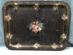 A large rectangular Victorian papier-mâché Jennens & Bettridge tray painted with floral sprays on