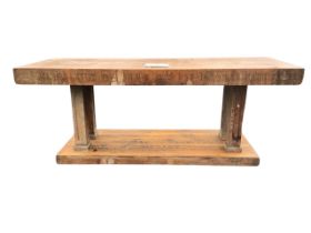 An oak altar table, the rectangular top inset with a square sandstone tablet, the apron carved