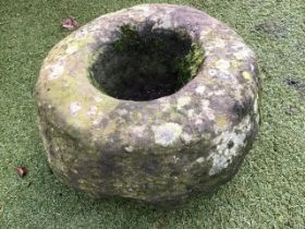 A circular ancient stone mortar of bowl shape. (19in)