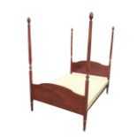 A Stag mahogany Georgian style four-poster bed, the shaped head and footboards with turned