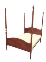 A Stag mahogany Georgian style four-poster bed, the shaped head and footboards with turned