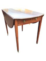 A Georgian mahogany pembroke table, the oval moulded top with two leaves supported on brackets above