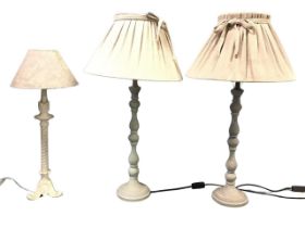 A pair of painted tablelamps, the baluster turned columns on circular bases, with pleated linen