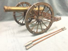 A large model of a 17th century field cannon, the brass barrel cast with royal arms and foliate