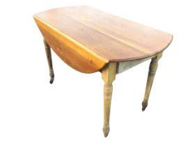 A Victorian hardwood pembroke table, the oval top with two leaves supported on brackets above a