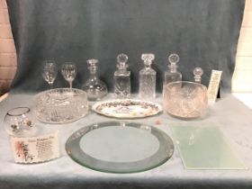 Miscellaneous glass including cut glass decanters and fruit bowls, a bevelled mirrored plateau table