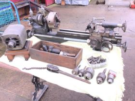 An engineers bench lathe complete with a selection of chucks, the machine with an associated