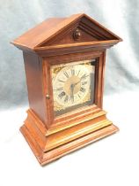 An Edwardian oak architectural hour striking mantel clock, the pedimented top above a moulded