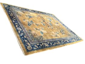 A Chinese Peking carpet, the yellow ground woven with scattered precious objects among clouds,