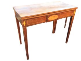 A Georgian mahogany fold-over-top tea table, the rectangular top with strung edges opening on a