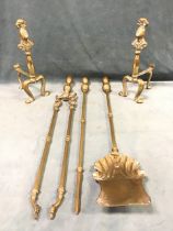 A set of brass fire irons with shovel, poker and tongs, having rounded knob handles; and a pair of