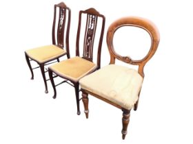 A pair of Edwardian mahogany salon chairs, the wavy backs above a pierced splats carved with