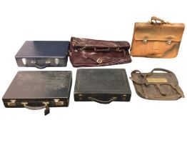 A European leather satchel case with brass mounts; a Swiss made leather briefcase; three rectangular