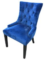 A contemporary side chair, the flared button upholstered back above a padded seat, raised on