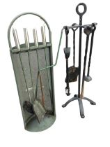 A set of wrought iron fire tools on stand with twisted shafts - poker, shovel, brush & tongs; and