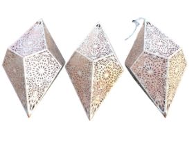 A set of three diamond shaped metal pentagonal hanging lanterns, with pierced snowflake style