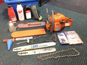 A Husqvarna chain saw, complete with spare blade, oil, spanners, chains, tools, etc. (A lot)