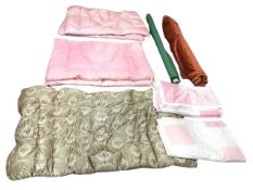 A pair of pink down-filled quilted conterpanes; a pair of pink patchwork cotton bed covers; a down