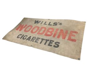 A 1940s Wills Woodbine cigarettes stencilled canvas advertising banner, with brass suspension