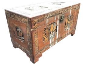 A Chinese camphorwood coffer with scalloped brass hasp, the top, front and sides carved with