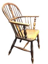 A Victorian oak and elm windsor armchair, the hooped spindle back and horseshoe shaped arms on