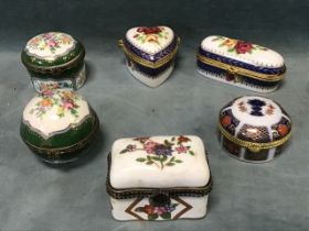 Six miscellaneous floral decorated porcelain trinket boxes with hinged covers and brass mounts -