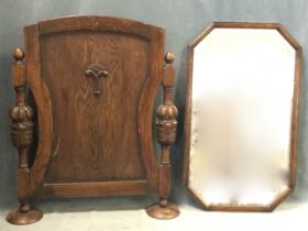 An octagonal oak framed bevelled wall mirror - 27.5in x 16.5in; and a jacobean style firescreen, the