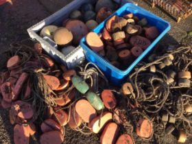 A large collection of fishing net floats or lobster pot buoys, some still with attached ropes -