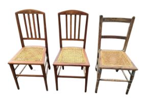 A pair of Edwardian mahogany chairs with arched crestrails inlaid with burr panels above slat