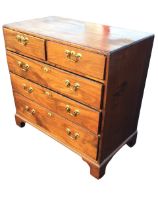 A George III mahogany chest of drawers, the moulded caddy top above two short and three long