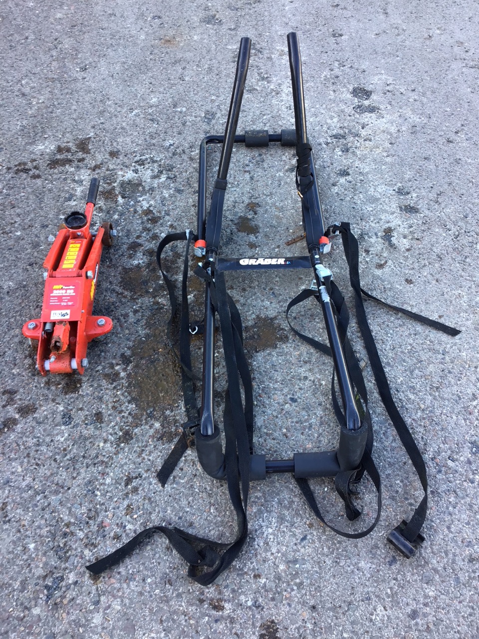 An MVP SuperLine 2000kg hand pumped hydraulic jack; and a Graber tubular steel car bicycle rack. (