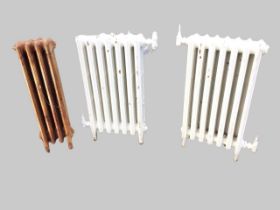 A pair of cast iron radiators, each with seven ribbed panels - 17in x 5.75in x 30in; and another