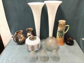 A pair of tall white glass lily vases on circular bases; a tall Dickens ware jug; a trio of cut