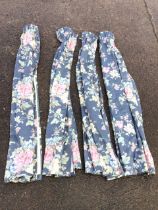 Two pairs of lined and gathered floral curtains printed with pink flowers on grey ground. (58in) (