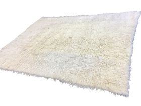 A Turkish handwoven shaggy pile white wool carpet. (96in x 123in)