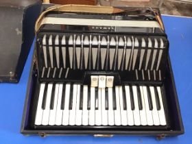 A cased Yamaha piano accordion with two octave keyboard, the black body having leather shoulder