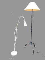 A wrought iron standard lamp, the column with foliate cast knops, raised on a tripod base with