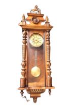 A C19th walnut Vienna wallclock, the shaped moulded crest with horse finial and lion head roundel