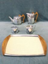 A 1960s Piquot Ware teaset with teapot, jug, cream, sucrié and tray. (5)