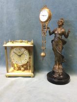 An Edwardian gilt brass and spelter swinger mystery clock, the classical draped figure signed M