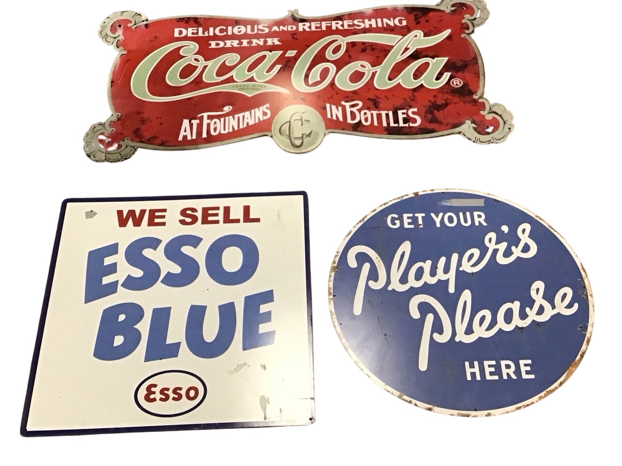 Three enamelled advertising signs - Coca Cola - 34in, Esso Blue - 18in, and Players Please - 17.