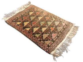 A Kurdish wool rug, the brown field with allover stylised leaf lattice motifs, within flowerhead,