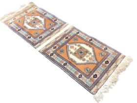 A Baluchi double ended saddle rug, the tan fields with zigzag framed medallions enclosing antelope