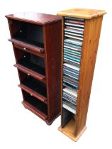 An oak faced CD rack with four brass knobbed drop-down compartments, raised on bun feet; and a