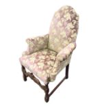 A C19th Queen Anne style armchair, the pink velvet brocade upholstered arched back above a sprung
