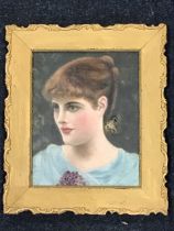 A Victorian oil on canvas, portrait of a young lady with a corsage of violets, in a period gilt