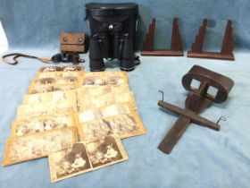 A Victorian stereoscope viewer with thirteen humorous, countryside and domestic slides; a pair of