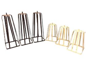 A set of three tapering wrought iron tablelamp stands of slatted construction; and another similar