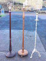 A mahogany standard lamp, the turned reeded acanthus carved column on a circular base with bun