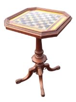 A Victorian mahogany octagonal chess table, the reverse glass painted chessboard within a moulded